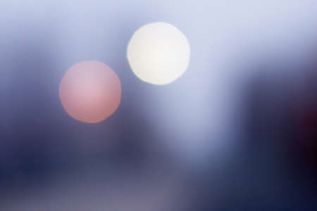 Colorful blue foggy bokeh background, pink and white round blurred spots.の写真素材