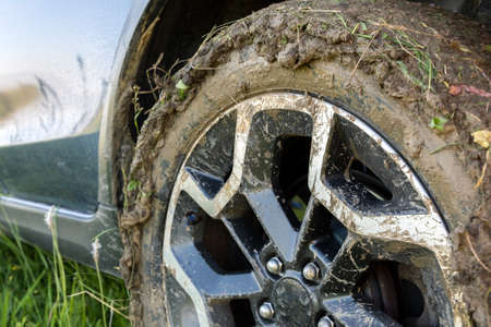 Close up of dirty off road car wheels with dirty tires covered with yellow mud.の写真素材
