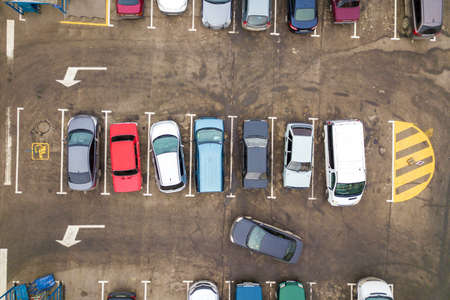 Top down aerial view of many cars on a parking lot of supermarket or on sale car dealer market.のeditorial素材