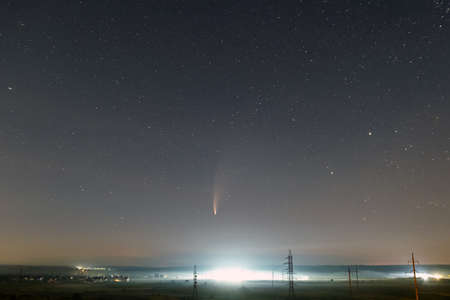 C / 2020 F3 (NEOWISE) comet with light tail in dark night sky.の写真素材