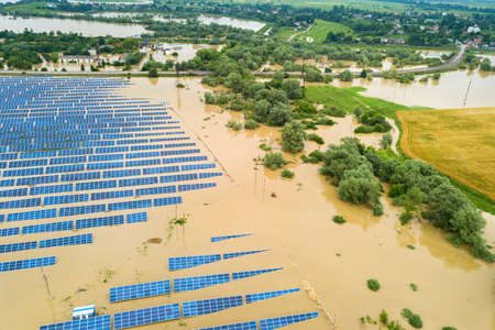 Aerial view of flooded solar power station with dirty river water in rain season.の写真素材