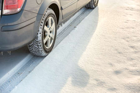 Close-up of car wheels rubber tire in deep snow. Transportation and safety concept.の写真素材