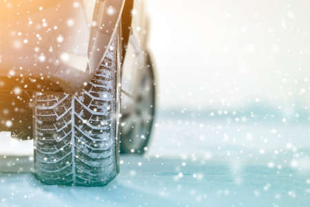 Close-up of car wheels rubber tires in deep winter snow. Transportation and safety concept.の写真素材