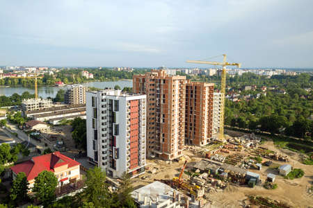 Aerial view of tall residential apartment buildings under construction. Real estate development.
