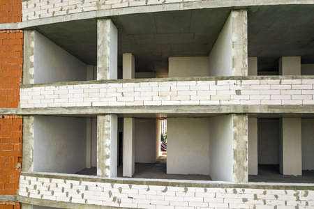 Rooms interior of new apartment building facade under construction.