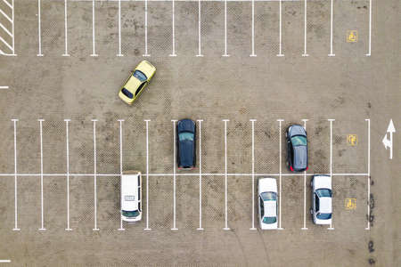 Top down aerial view of many cars on a parking lot of supermarket or on sale car dealer market.の写真素材