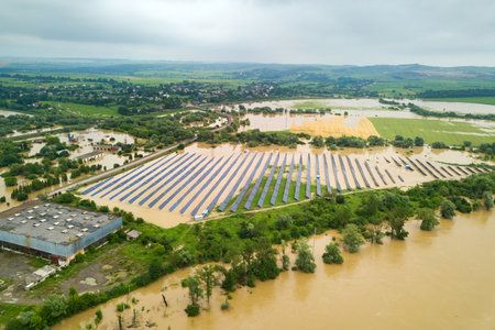Aerial view of flooded solar power station with dirty river water in rain season.の写真素材