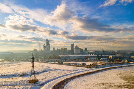 Aerial view of cement plant with high factory structure and tower crane at industrial production area.の写真素材