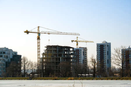 Aerial view of tower cranes and high residential apartment buildings under construction. Real estate development.のeditorial素材