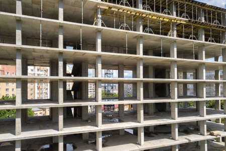 Aerial view of high frame of monolithic concrete building under construction. Real estate...