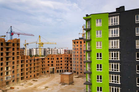 Aerial view of city residential area with high apartment buildings under construction.