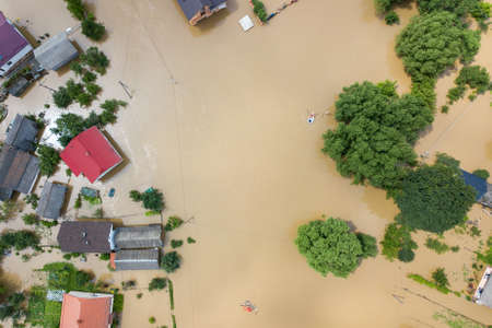 Aerial view of flooded houses with dirty water of Dnister river in Halych town, western Ukraine.の写真素材