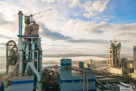 Aerial view of cement plant with high factory structure and tower crane at industrial production area.の写真素材