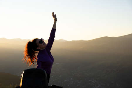 Young happy woman enjoying extreme ride on atv quad motorbike in autumn mountains at sunset.