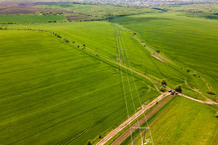 Aerial landscape view of green cultivated agricultural fields with growing crops on bright summer day.の写真素材