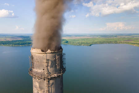 Aerial view of coal power plant high pipes with black smokestack polluting atmosphere. Electricity production with fossil fuel concept.の写真素材