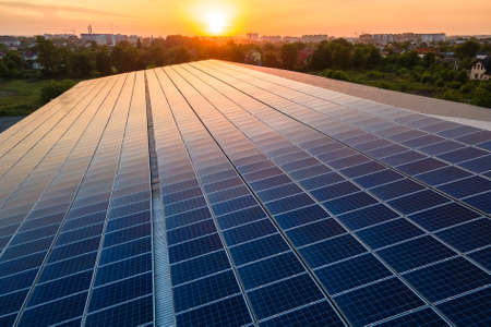 Blue photovoltaic solar panels mounted on building roof for producing clean ecological electricity...