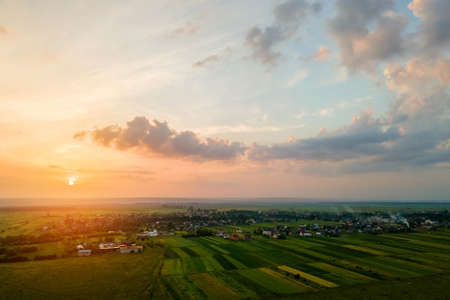 Aerial view of residential houses in suburban rural area at sunset.の写真素材