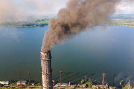 Aerial view of coal power plant high pipes with black smokestack polluting atmosphere. Electricity production with fossil fuel concept.の写真素材