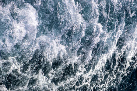 Top down aerial view of sea water surface. White foam waves texture as natural background.の写真素材