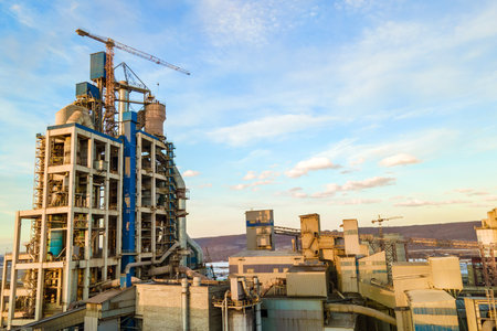 Aerial view of cement plant with high factory structure and tower crane at industrial production area.の写真素材