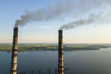 Aerial view of coal power plant high pipes with black smoke moving up polluting atmosphere.の写真素材