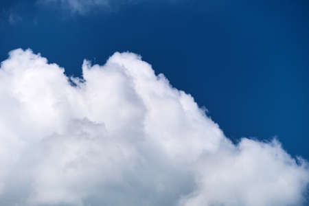 Bright landscape of white puffy cumulus clouds on blue clear sky.の写真素材