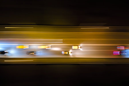 Aerial view of road with fast moving heavy traffic at night. Top view of urban transportation. Rush...