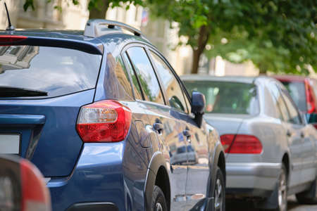 City traffic with cars parked in line on street side