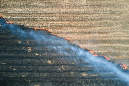 Aerial view of grassland field burning with red fire during dry season. Natural disaster and climate change conceptの写真素材