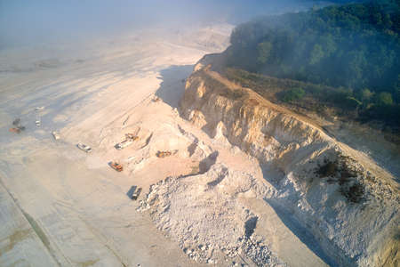 Aerial view of open pit mining of limestone materials for construction industry with excavators and dump trucksの写真素材