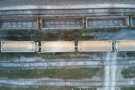 Aerial view of cargo train loaded with crushed stone materials at mining factory. Railway transportation of grinded limestone oreの写真素材