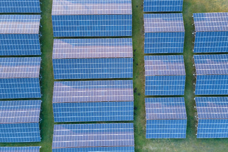 Aerial view of large sustainable electrical power plant with rows of solar photovoltaic panels for producing clean ecological electric energy. Renewable electricity with zero emission concept.の写真素材