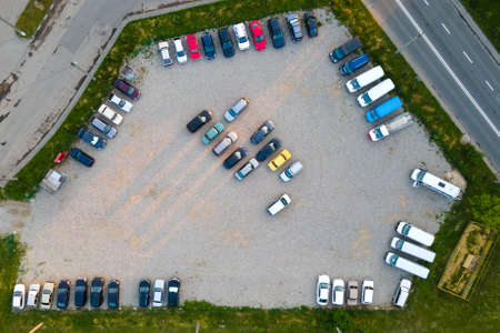Aerial view of many colorful cars parked on parking lot in eveningの写真素材