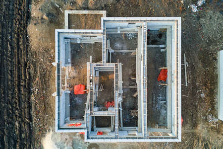 Aerial view of unfinished frame of private house foundation under constructionの写真素材