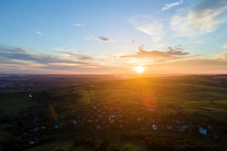 Aerial view of residential houses in suburban rural area at sunset