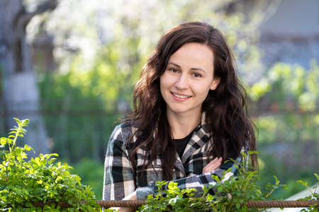 Portrait of happy pretty young woman outdoors on spring sunny dayの写真素材