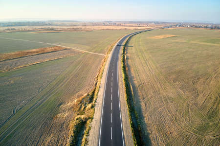 Aerial view of empty intercity road at sunset. Top view from drone of highway in evening