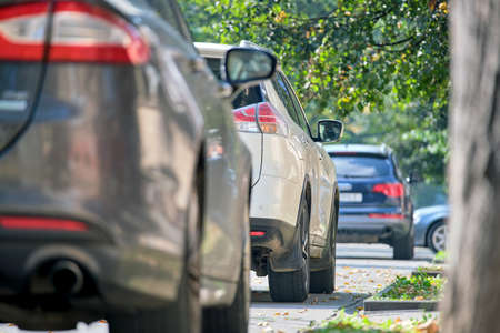 City traffic with cars parked in line on street side