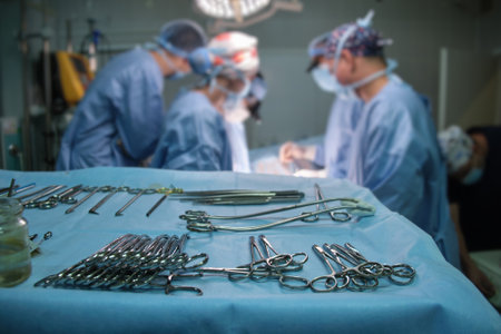 Closeup of surgical tools on table and team of surgery doctors operating a patient in hospital room