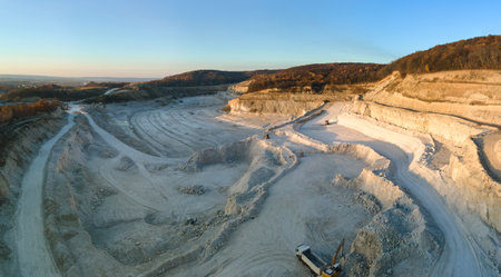 Aerial view of open pit mining site of limestone materials for construction industry with excavators...