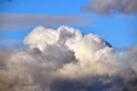 Bright landscape of white puffy cumulus clouds on blue clear skyの写真素材