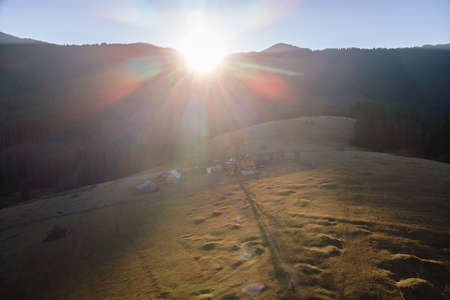Aerial view of mountain hillside with small shepherd huts in eveningの写真素材
