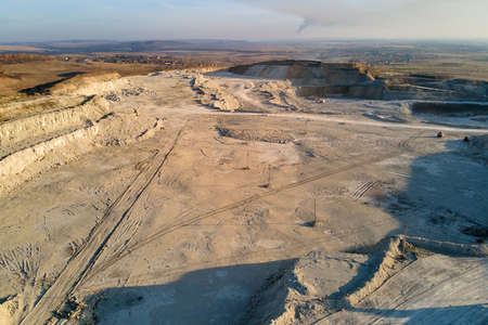 Aerial view of open pit mining site of limestone materials for construction industry with excavators and dump trucksの写真素材