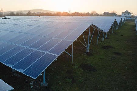 Aerial view of large sustainable electrical power plant with rows of solar photovoltaic panels for producing clean ecological electric energy. Renewable electricity with zero emission concept.の写真素材