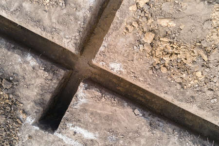 Dug out trench for building works of new house concrete foundation on construction siteの写真素材