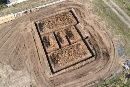 Dug out trench for building works of new house concrete foundation on construction site