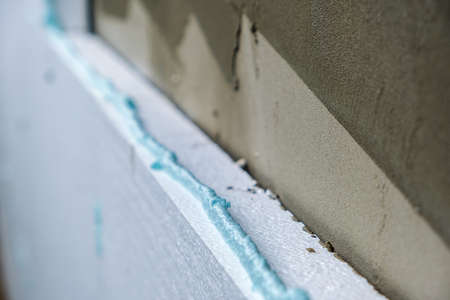 Installation of insulation sheets on house facade wall for thermal protectionの写真素材