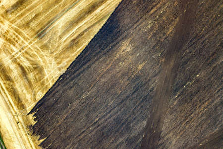 Aerial view of plowed agricultural field prepared for planting crops in springの写真素材