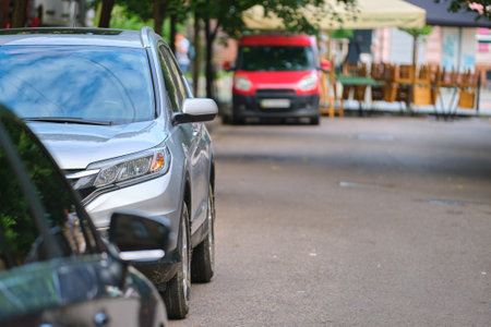 City traffic with cars parked in line on street sideの写真素材